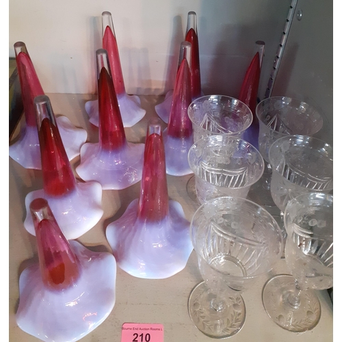 210 - A set of six etched wine glasses and nine epergne glass conical vases in cranberry with milk shading... 