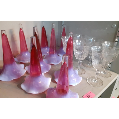 210 - A set of six etched wine glasses and nine epergne glass conical vases in cranberry with milk shading... 