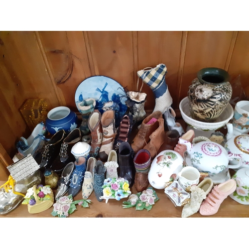 214 - A collection of shoe ornaments and other collectables to include V&A Museum collectable  teapots, We... 