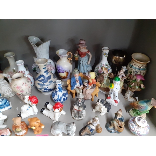 246 - A quantity of 20th century collectables, mainly vases, figures and models of animals to include a Po... 