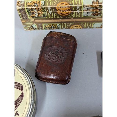 253 - Mixed smoking related items to include cigar box and tin, leather holders, leather embossed vesta ca... 