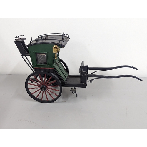 258 - A model horse-drawn carriage constructed of wood and metal, painted green, red and black, 21cm H x 4... 