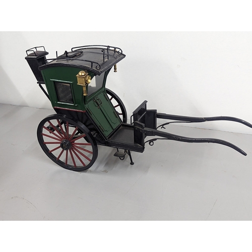 258 - A model horse-drawn carriage constructed of wood and metal, painted green, red and black, 21cm H x 4... 