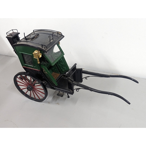 258 - A model horse-drawn carriage constructed of wood and metal, painted green, red and black, 21cm H x 4... 