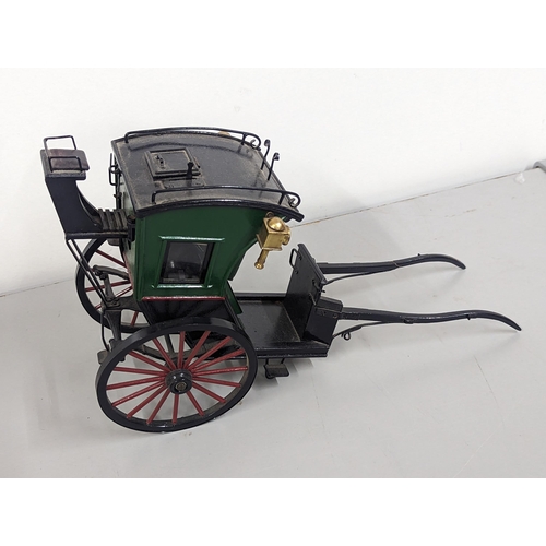 258 - A model horse-drawn carriage constructed of wood and metal, painted green, red and black, 21cm H x 4... 