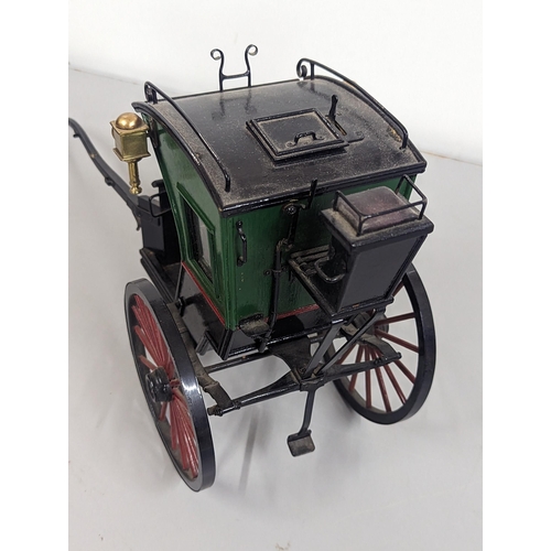 258 - A model horse-drawn carriage constructed of wood and metal, painted green, red and black, 21cm H x 4... 