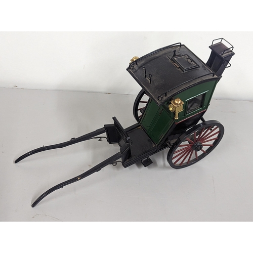 258 - A model horse-drawn carriage constructed of wood and metal, painted green, red and black, 21cm H x 4... 