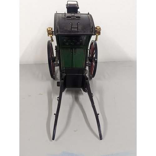 258 - A model horse-drawn carriage constructed of wood and metal, painted green, red and black, 21cm H x 4... 