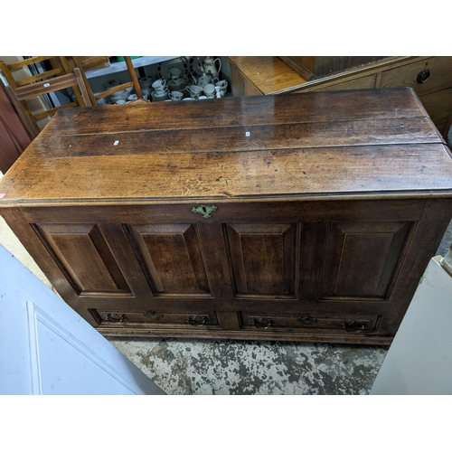 265 - A 19th century oak farmhouse deep wooden chest, panelled front, sides and back, two base drawers, ov... 