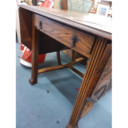 287 - An early 20th century oak carved octagonal topped fall flap table having a singe inset drawer, 74cm ... 