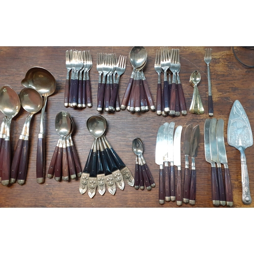 291 - Vintage 'bronzed' and wooden handled cutlery and flatware together with six Thai spoons with images ... 