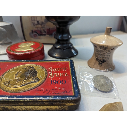 303 - A mid lot to include a Boer War 1900 South Africa chocolate tin, composition bust of Sir Winston Chu... 