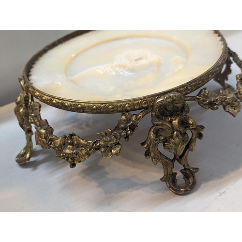 31 - A 19th century gilt-bronze and mother-of-pearl table centrepiece, of circular form, the central moth... 