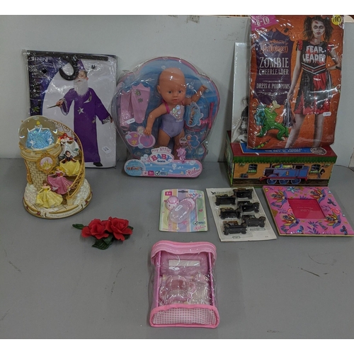 316 - A mixed lot to include Walt Disney Cinderella, and others snow globe, a boxed 'My little baby born' ... 