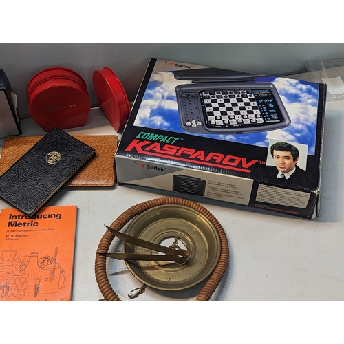 327 - A mixed lot to include a boxed Polaroid camera, electronic chess set, vintage games, model Carthagin... 