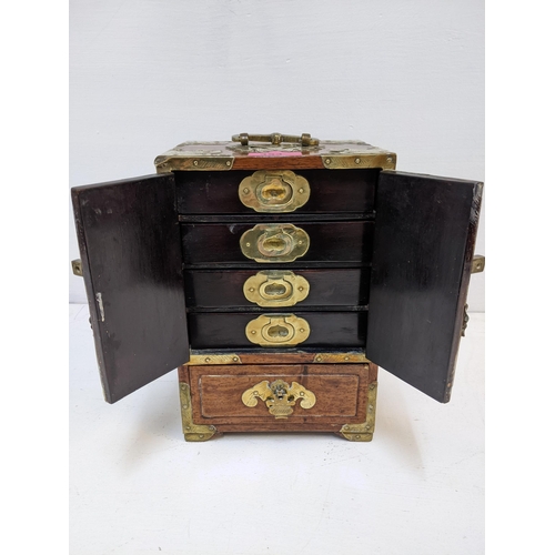 353 - A Chinese wooden and brass mounted desk cabinet, twin doors revealing four internal drawers and one ... 