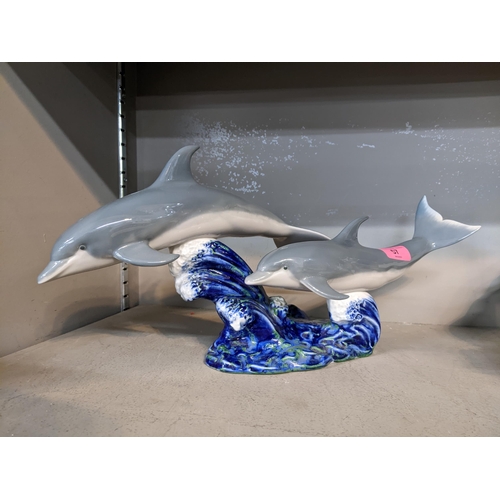 57 - A Lladro porcelain model group of two dolphins above crashing waves, model number 6456, impressed an... 