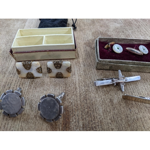 62 - A group of silver and other cuff links and tie pins to include a pair of modernist hammered silver w... 