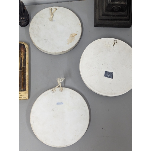 83 - A mixed lot to include Classical Bisque style plaques and others, along with a replica Phestas Discu... 