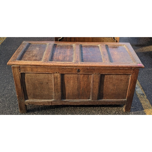 12 - A late 17th century oak panelled coffer having a hinged top and on block shaped feet, 60cm h x 130cm... 