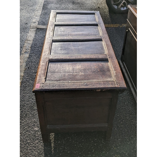 12 - A late 17th century oak panelled coffer having a hinged top and on block shaped feet, 60cm h x 130cm... 