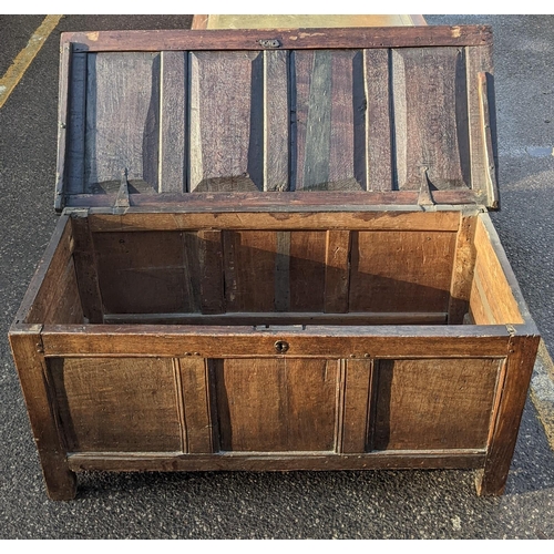 12 - A late 17th century oak panelled coffer having a hinged top and on block shaped feet, 60cm h x 130cm... 