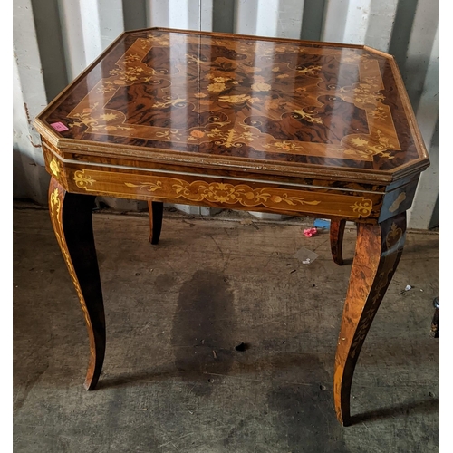 13 - An Italian marquetry inlaid octagonal topped games table having a floral inlaid lift off top above a... 