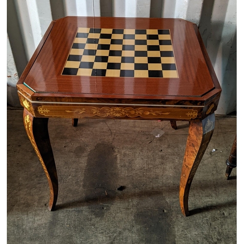 13 - An Italian marquetry inlaid octagonal topped games table having a floral inlaid lift off top above a... 