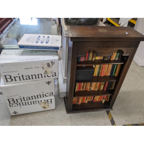 148 - A mid 20th century oak open bookcase containing mixed books together with a collection of boxed Brit... 