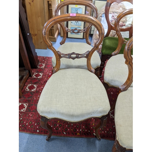 26 - A set of four Victorian walnut balloon back dining chairs together with a set of four cloud back cha... 