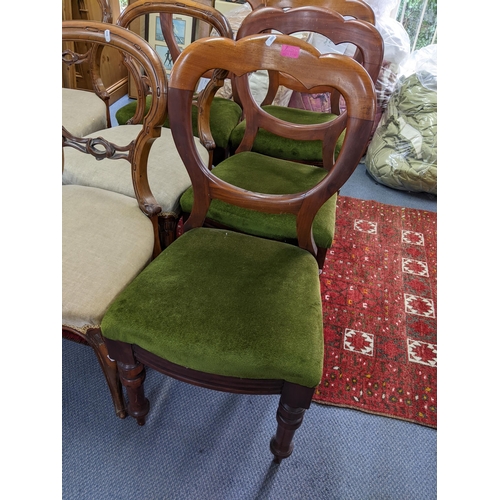 26 - A set of four Victorian walnut balloon back dining chairs together with a set of four cloud back cha... 