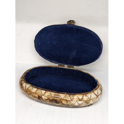 27 - A mid 20th century camel bone trinket box of oval form and with brass fittings, 5cm h x 16.5cm w
Loc... 