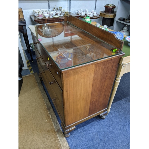 280 - A mid 20th century walnut chest of three long drawers having a raised back and on short cabriole fee... 