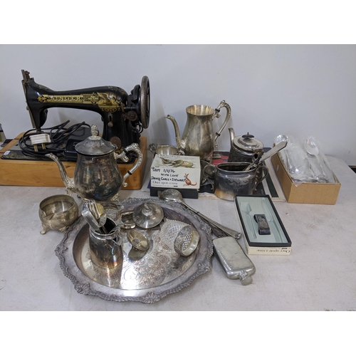 283 - A mixed lot to include a silver plated tray, tea pot, cutlery, Singer sewing machine and other items... 