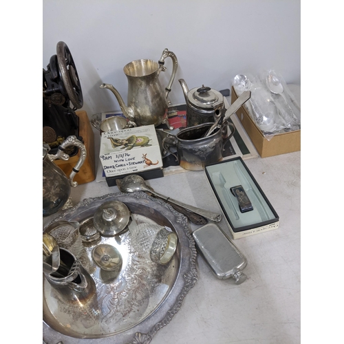 283 - A mixed lot to include a silver plated tray, tea pot, cutlery, Singer sewing machine and other items... 