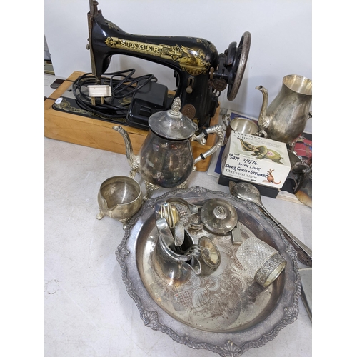 283 - A mixed lot to include a silver plated tray, tea pot, cutlery, Singer sewing machine and other items... 