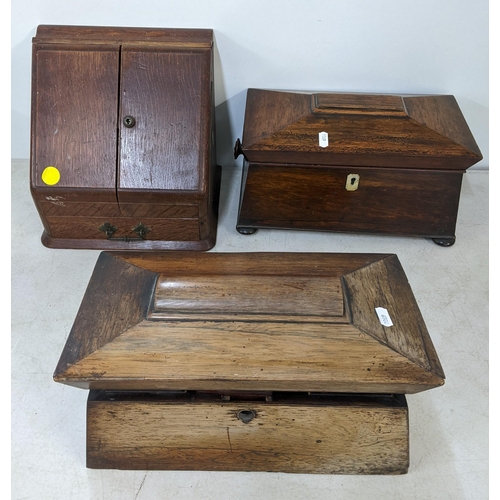 285 - Two 19th century rosewood sarcophagus, formed teacaddy's together with an oak stationery desk tidy
L... 