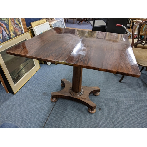 3 - A William IV rosewood foldover card table having a tapered column and on bun shaped feet, 75cm h x 9... 