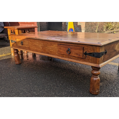 76 - A vintage teak rectangular topped coffee table with two drawers and wrought iron supports, 46cm h x ... 