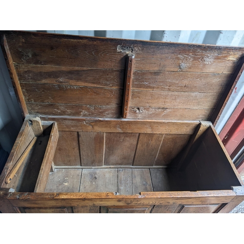 8 - An early 18th century oak panelled dower chest having inset candle tray box, two short drawers and o... 