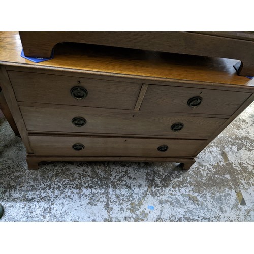 266 - Edwardian oak chest of two short and two long drawers with brass ring handles, on bracket feet, gilt... 