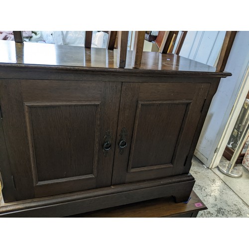 266 - Edwardian oak chest of two short and two long drawers with brass ring handles, on bracket feet, gilt... 