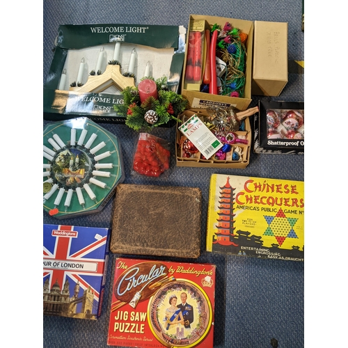 335 - A mixed lot to include jigsaw puzzles A/F and games along with Christmas decorations and other items... 