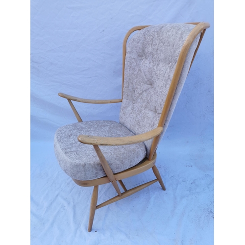 438 - A mid 20th century elm and beech Ercol easy chair, model 359, with open armrests, upholstered, with ... 