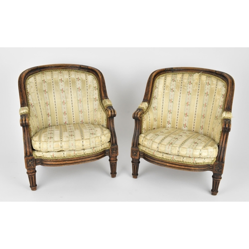 448 - A pair of 18th century French Louis XVI bergère armchairs, circa 1780, with channelled mahogany rail... 