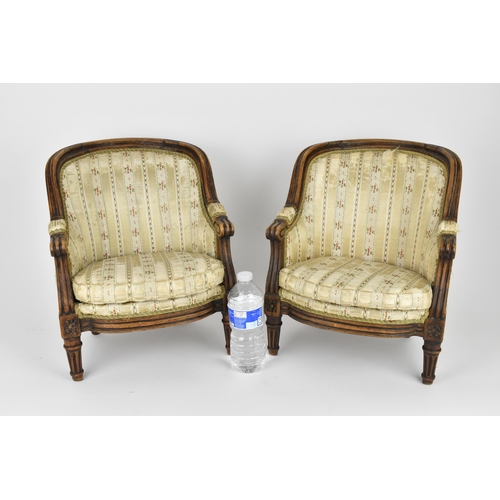 448 - A pair of 18th century French Louis XVI bergère armchairs, circa 1780, with channelled mahogany rail... 