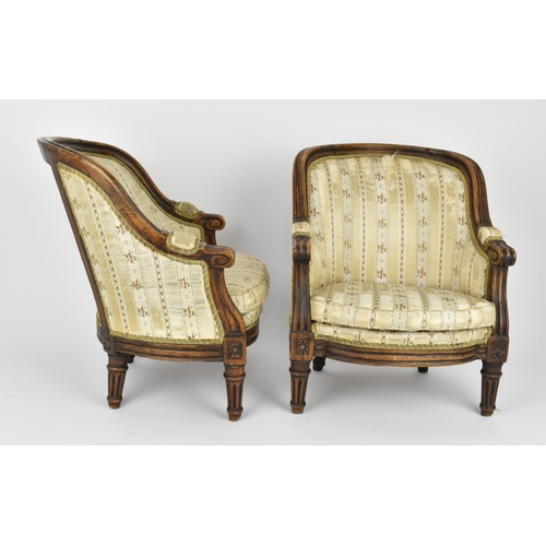 448 - A pair of 18th century French Louis XVI bergère armchairs, circa 1780, with channelled mahogany rail... 