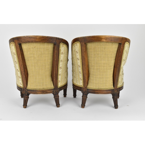 448 - A pair of 18th century French Louis XVI bergère armchairs, circa 1780, with channelled mahogany rail... 