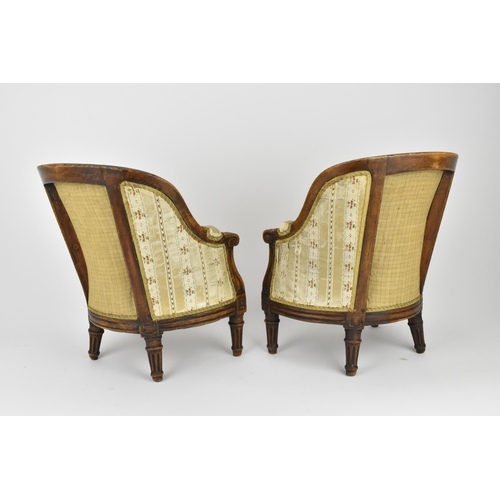 448 - A pair of 18th century French Louis XVI bergère armchairs, circa 1780, with channelled mahogany rail... 