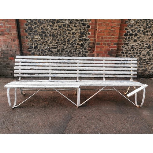 451 - A painted wood and wrought iron slatted garden bench, 87 cm high x 243 cm wide
Location: CON